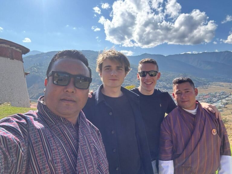 Kingdom of Happiness Tours guests with their Bhutanese guide above Paro valley