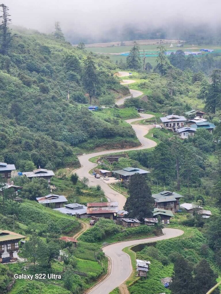 Winding road and village in a Bhutanese valley
